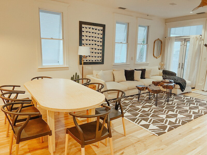 modern dining room with white table and black chairs