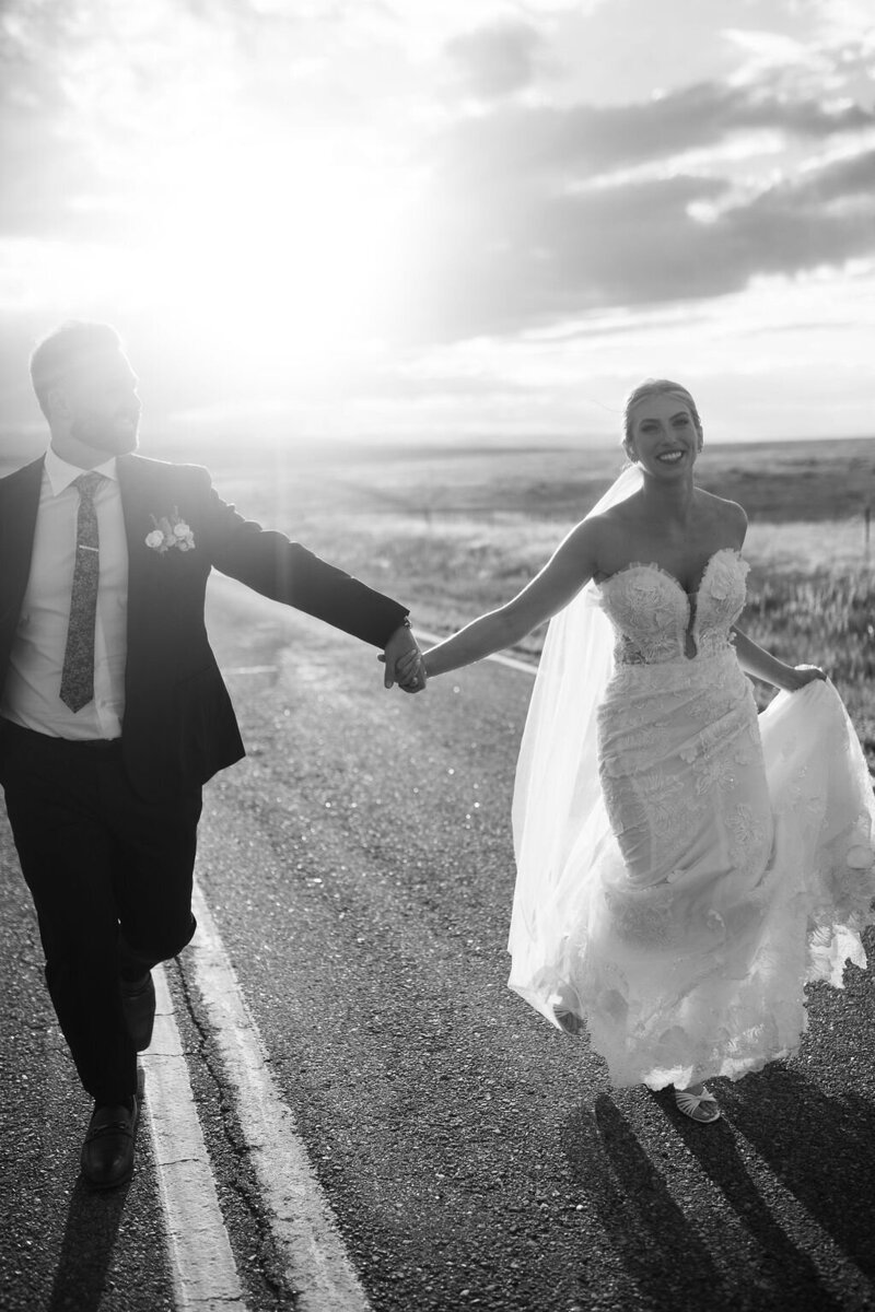 Black and white photo of Cerise and Geoff enjoying wedding cake together