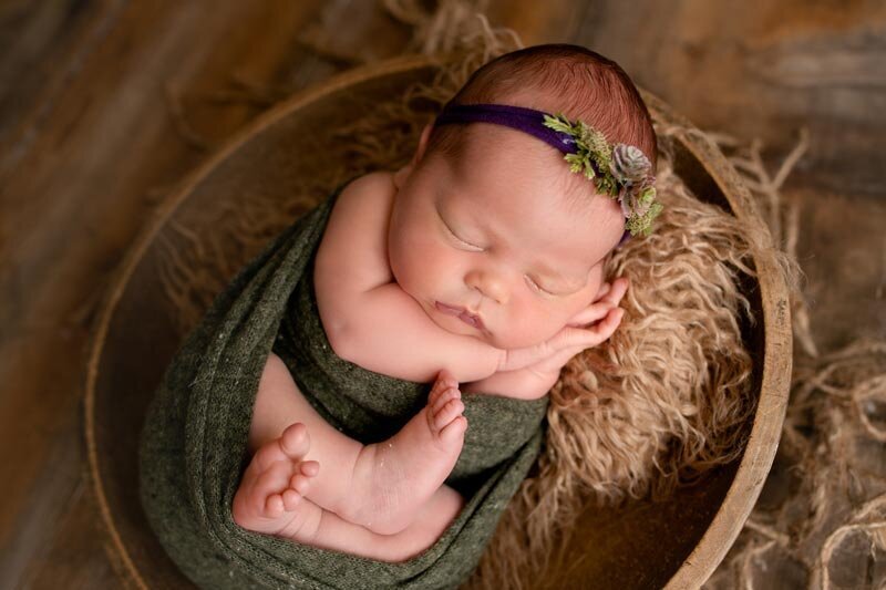 Ripon Wisconsin Newborn photo session baby  sleeping in bowl with hands out of wrap | Glory Be Photography by Tara Bos
