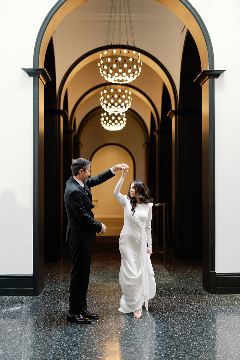 Bride and Groom dancing in the hallway of the Daxton- a small wedding venue in Birmingham MI. 