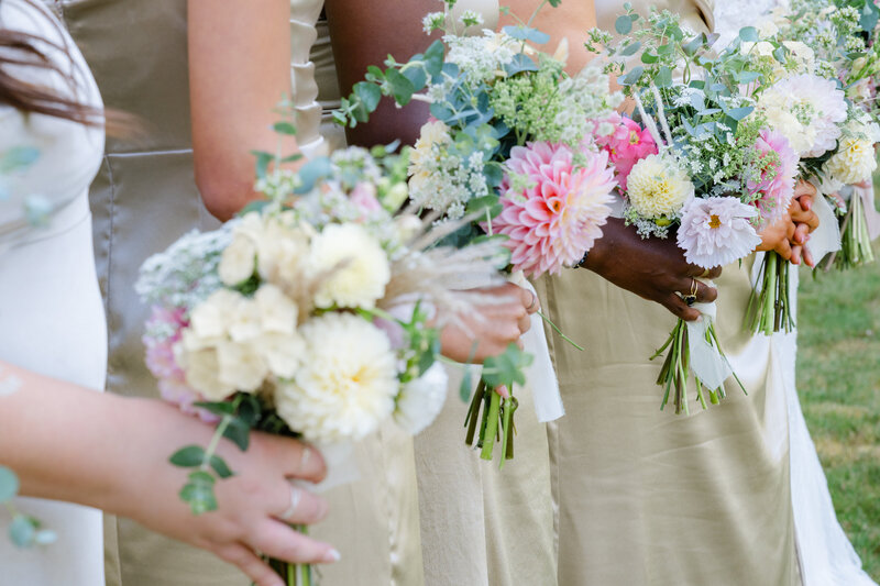 close detail pic bridesmaids in champagne dresses with summer bouquets