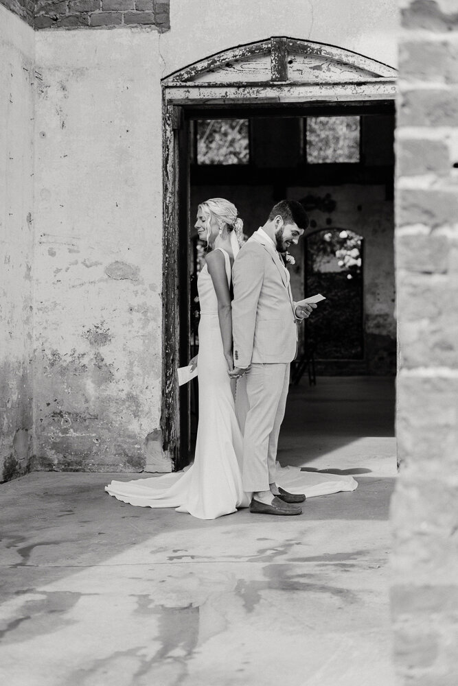 Bride and groom saying vows back to back