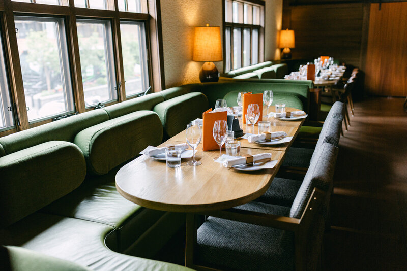 A detailed photograph showcasing the elegant rehearsal dinner setup at Bluebird Restaurant in Banff, featuring refined decor and a cozy mountain ambiance.
