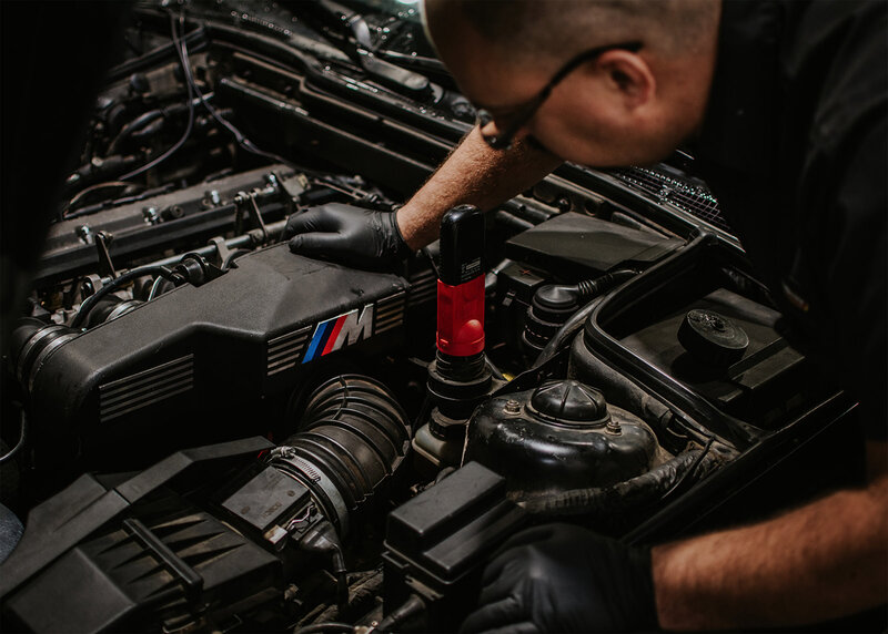 Man repairing BMW engine