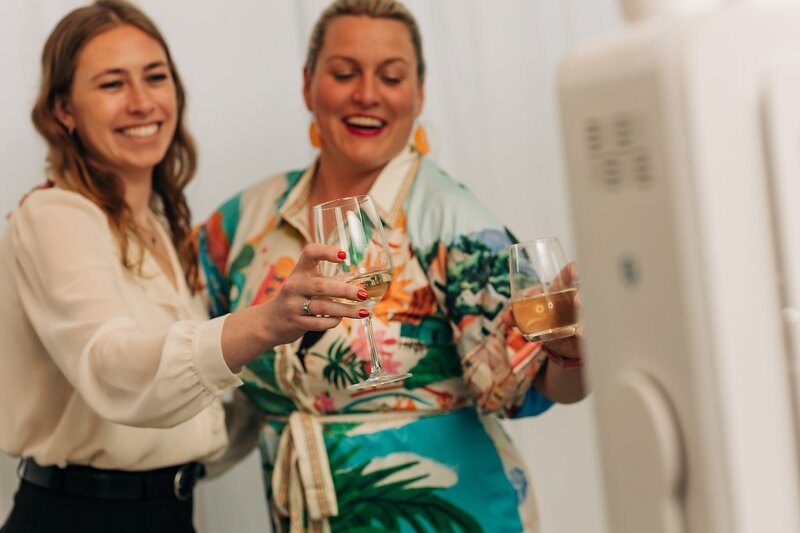 Friends toasting and celebrating during Dart Collective Chicago launch at Lou Lou by Lola Cafe