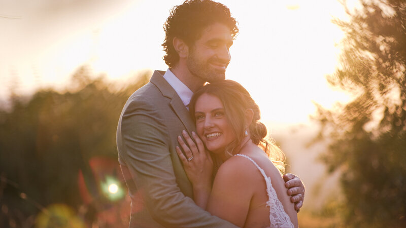 Still image from a Portugal wedding film. A wedding couple holding each other.