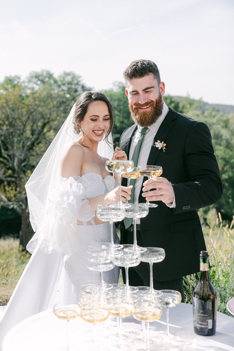 newlywed couple enjoying a champagne tower