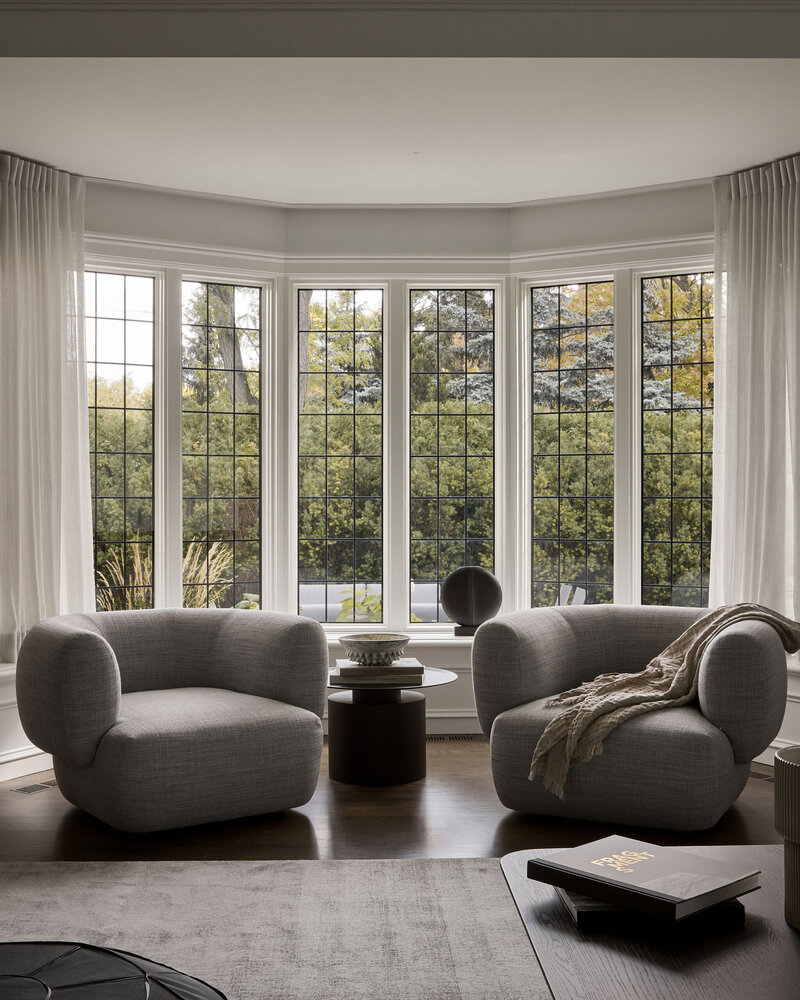 Modern seating vignette in front of grand bay window