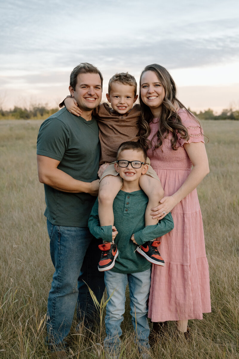 Family posing together during golden hour