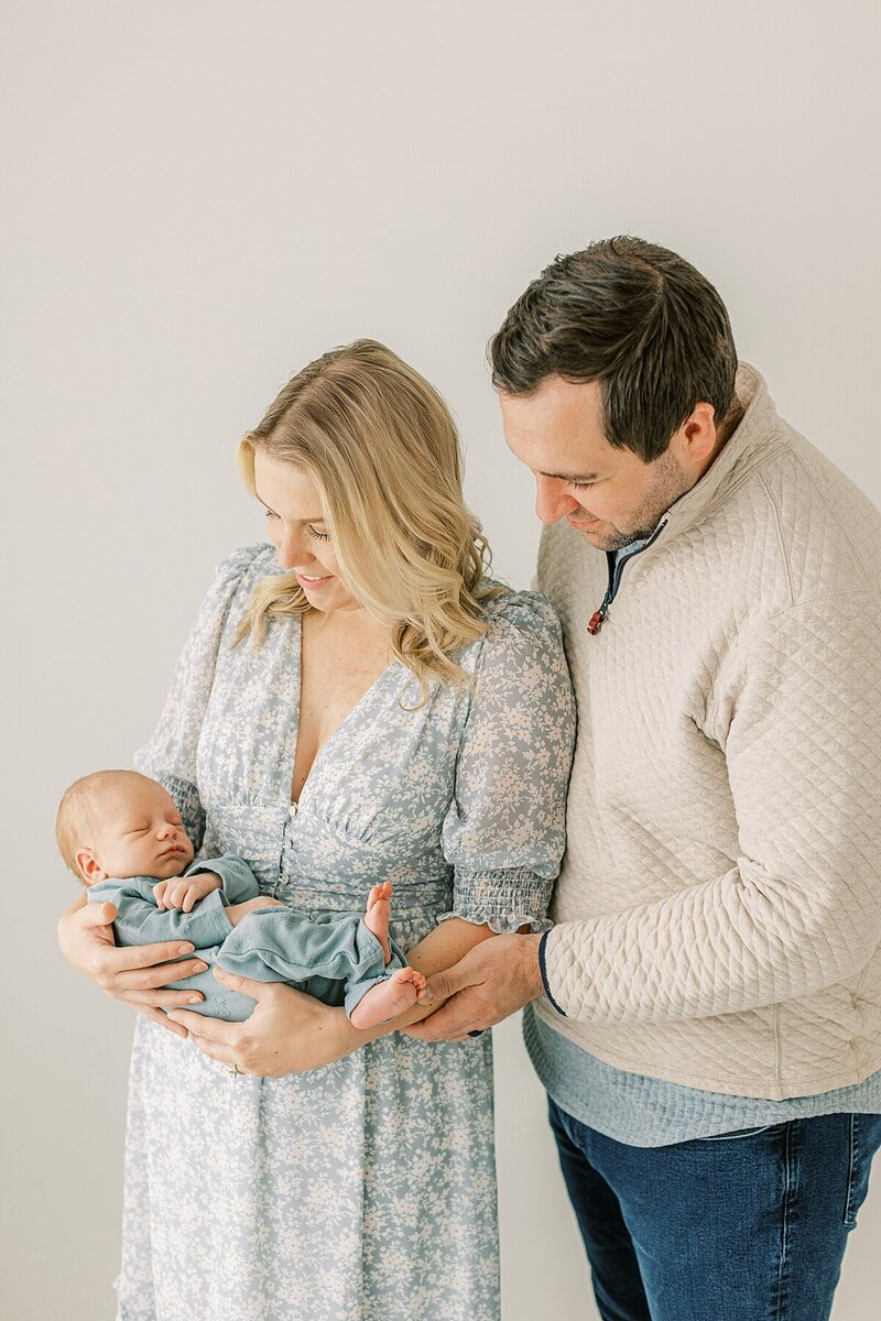 baby in blue newborn session in Lancaster, serving Harrisburg, Hershey in mom's arms