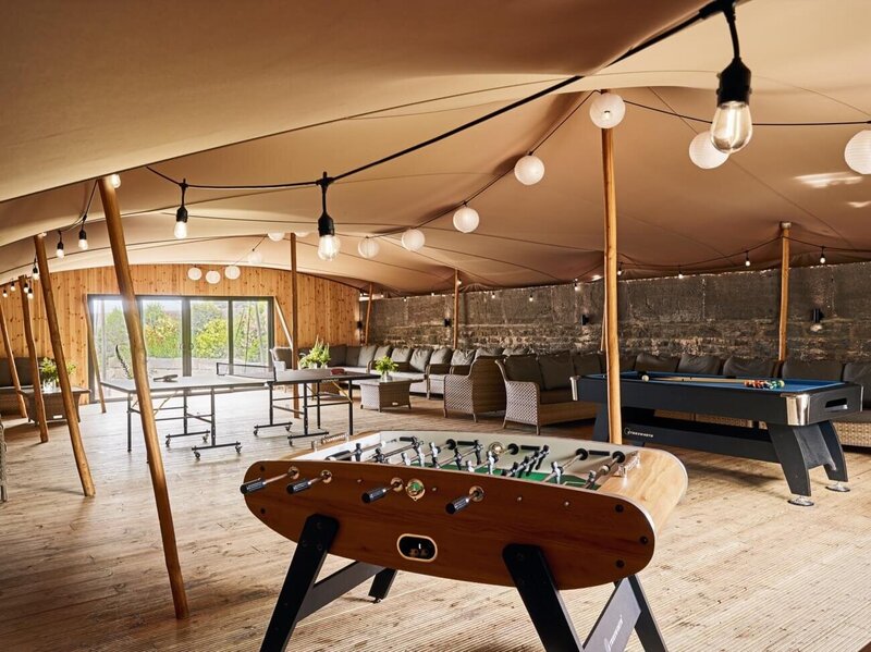 The terrace set up with a stretch marquee with casual seating and games