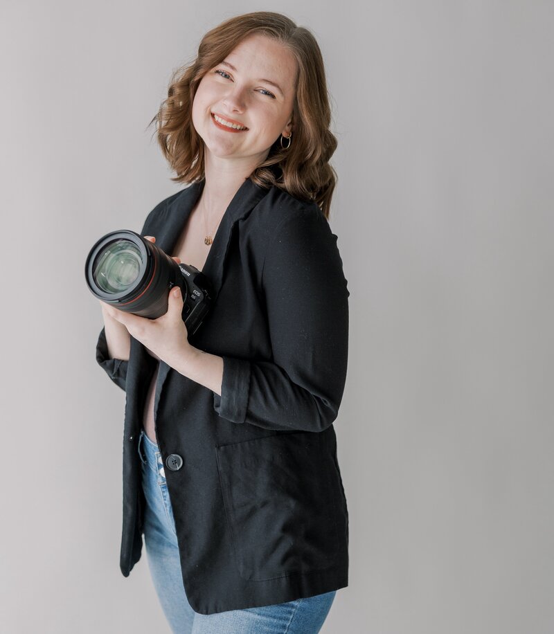 A photographer holds her camera in a Richmond studio headshot session.
