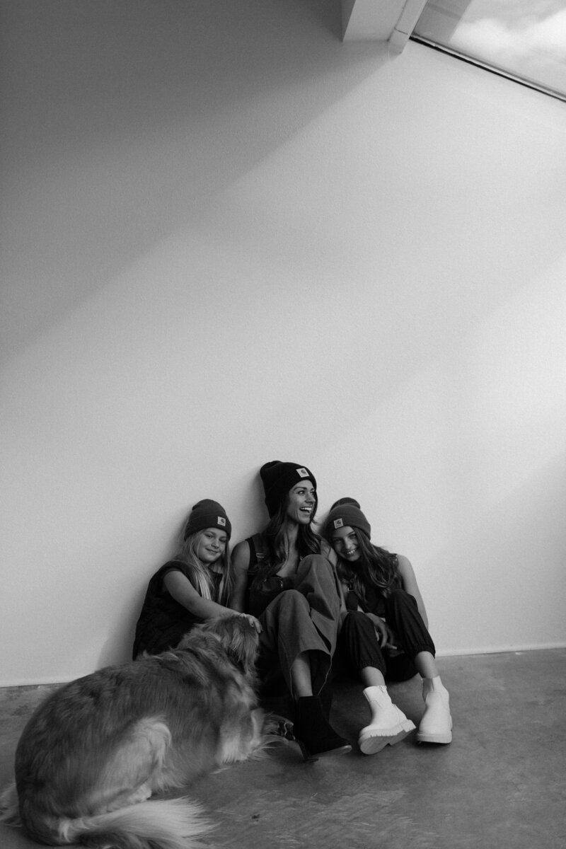 spenser chambers and her daughters and dog in a black and white studio photo