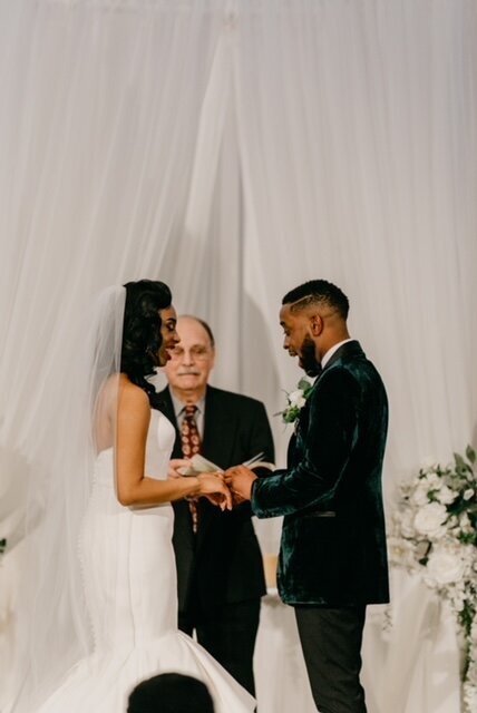 real bride wearing a custom bridal veil while she and her groom say their vows.