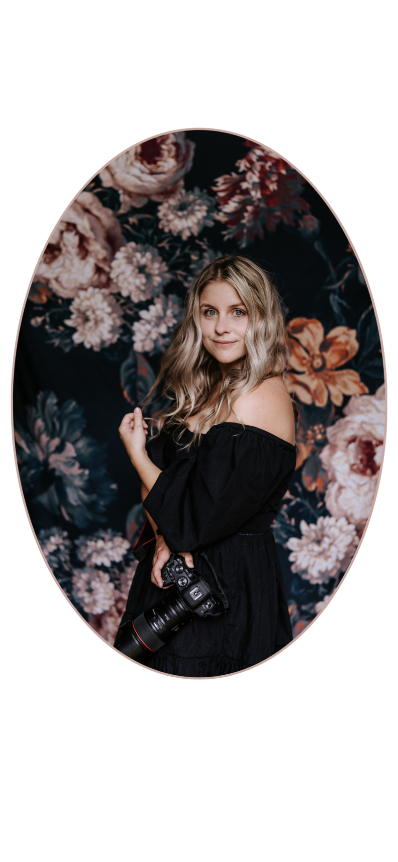 Kayla Aspen holding camera in front of Floral backdrop