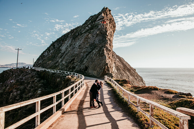 Couple walking along the scenic cliffs at Lands End in San Francisco during their coastal elopement, captured by San Francisco elopement photographer Kristin Smith.