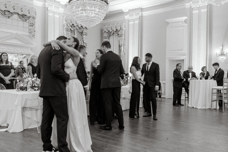 Toby and Jeff share a romantic first dance at Arlington Hall in Dallas, Texas, surrounded by family and friends in an elegant ballroom setting.