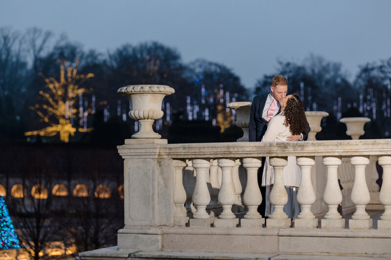 A Longwood Gardens Christmas engagement photo during sunset. Photo by Christopher Ginn Studios.