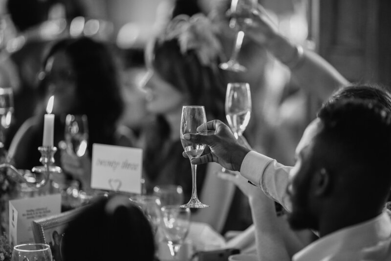 Guests at a table under lights by Nashville event planners Siena & Co.