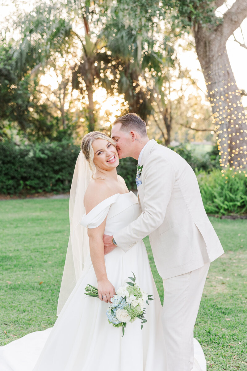 groom kissing bride on the head