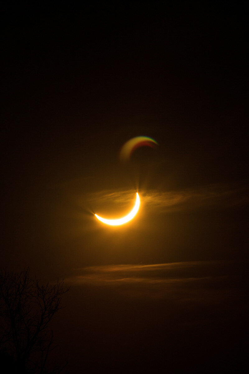 Frau die um ein Lagerfeuer tanz bei Sonnenuntergang