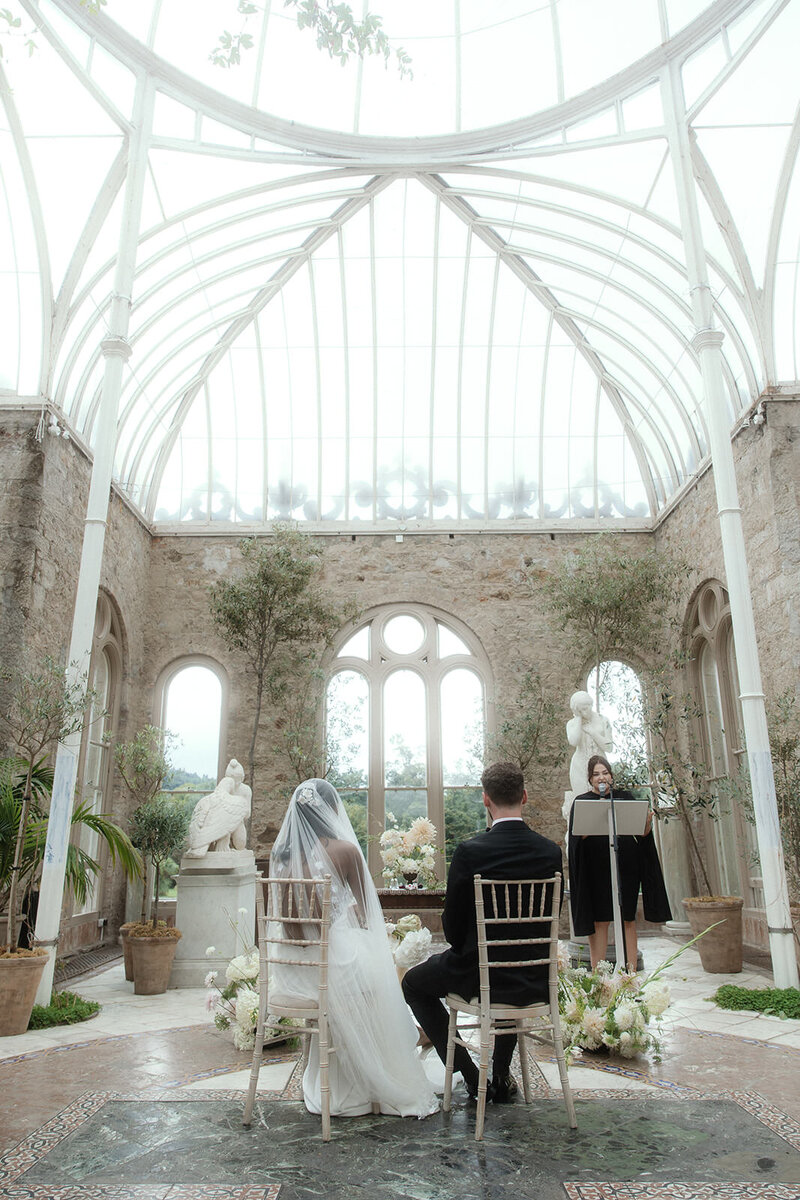 Bride and groom sitting at the alter   in Killruddery House and Gardens, Wicklow