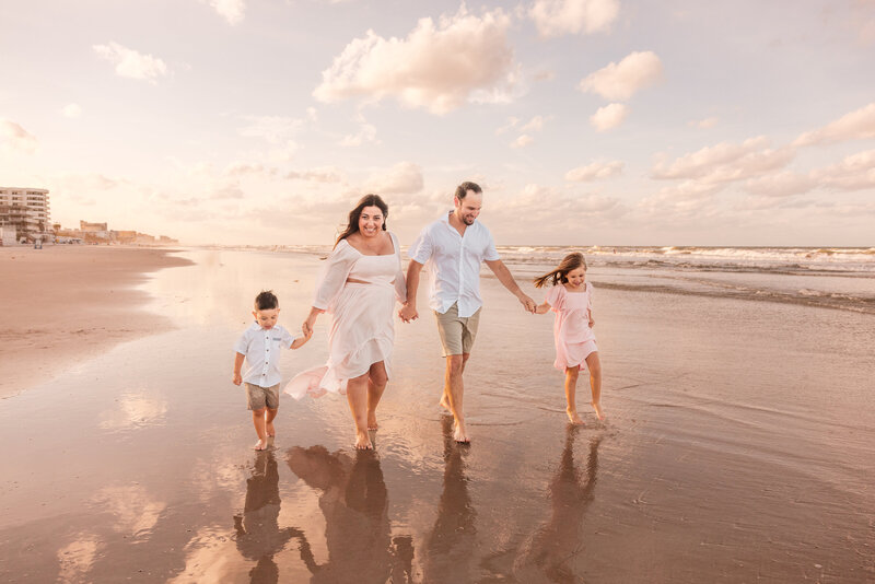 Children playing at the shoreline during family session in Central Florida

