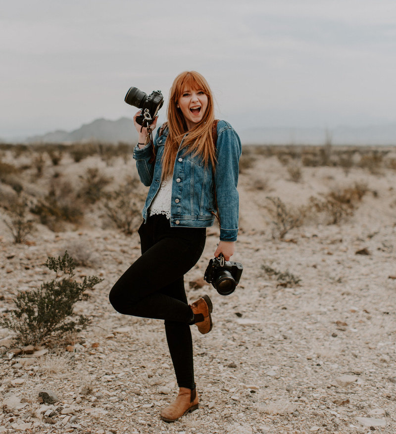 woman smiling and holding camera