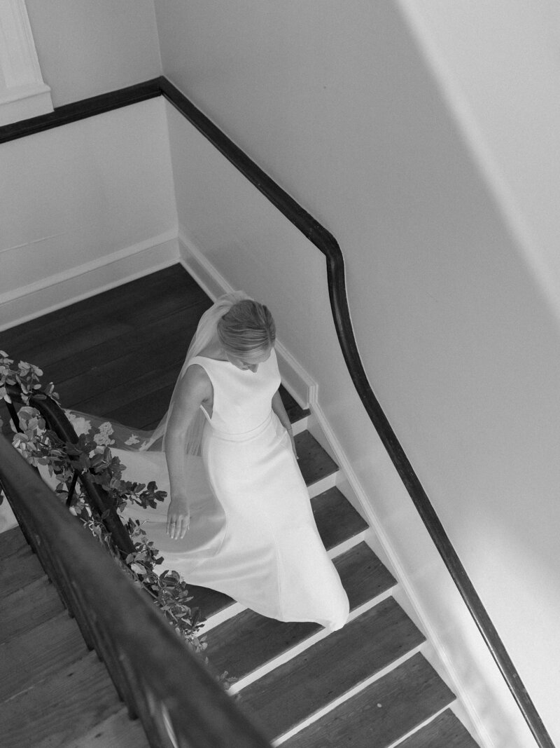 Bride walking down grand staircase
