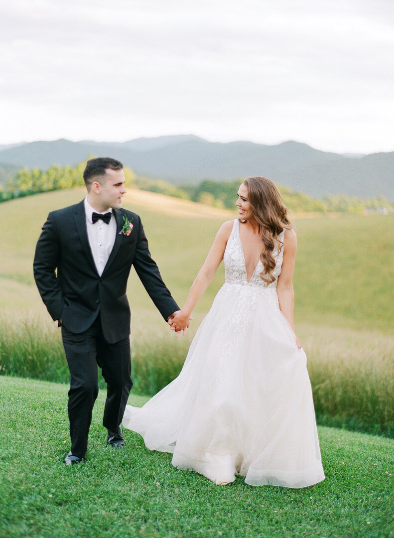 Bride and Groom Walking Holding Hands at The Ridge Asheville Photo