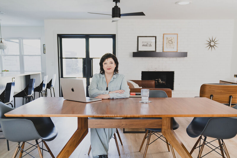 Desiree Peterson in her office while on her laptop in a promotional photoshoot