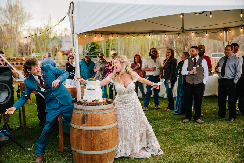 Jackson Hole videographer captures bride and groom cutting cake after Grand Teton wedding
