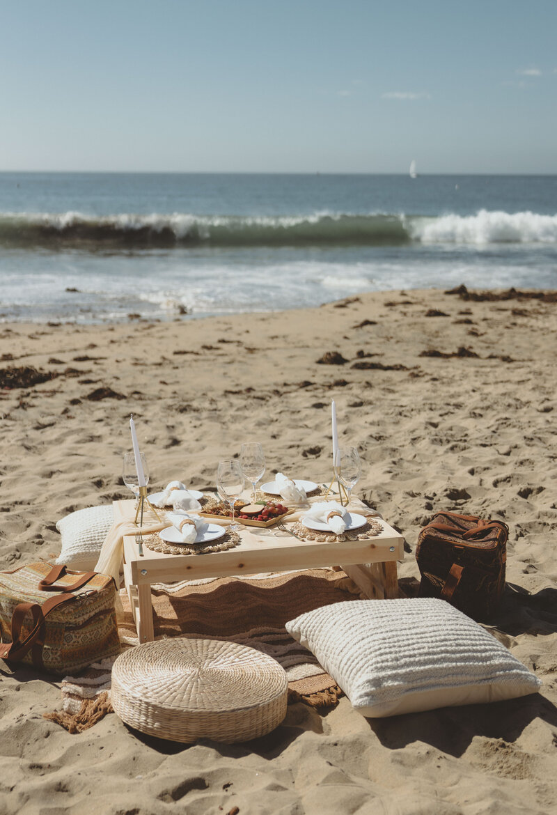 Let's Picnic Co. - Boho Picnic table with neutral tones on beach in Corona Del Mar California