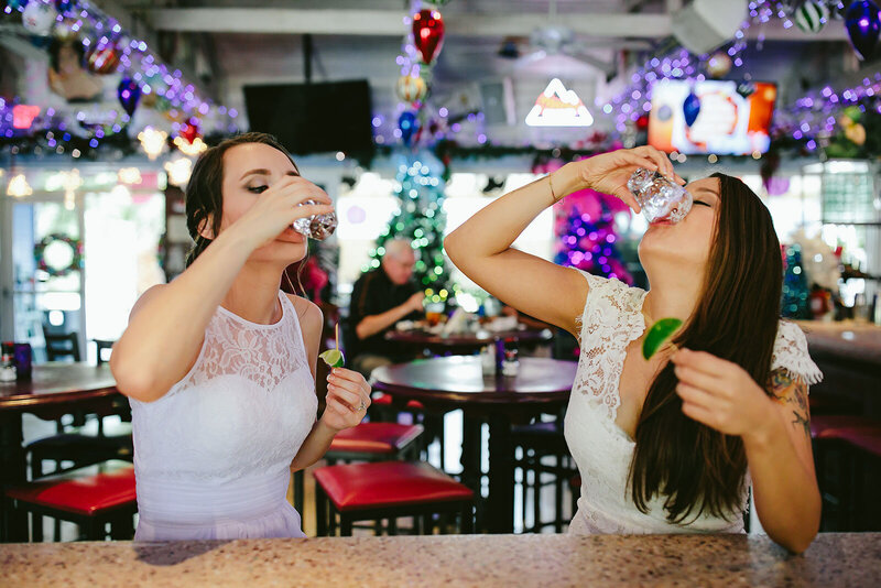 Lesbian Brides taking shots before their Micro Wedding Ceremony