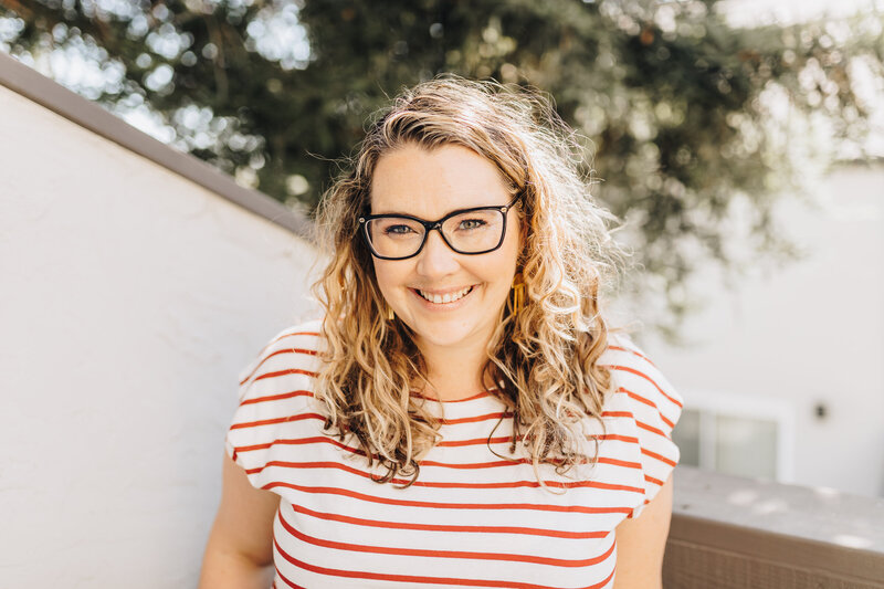 Woman smiles at the camera in the sunshine