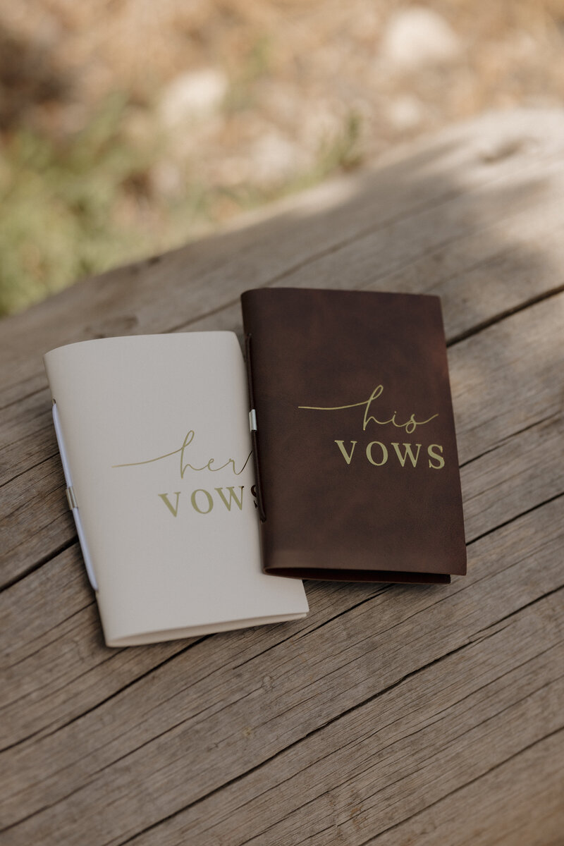 Handwritten bride and groom vow books captured in a soft, editorial detail shot, embodying timeless romance in a McCall, Idaho destination wedding.