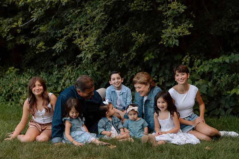 family nuzzle closely in field