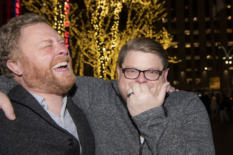 A couple with their arms around each other laughing