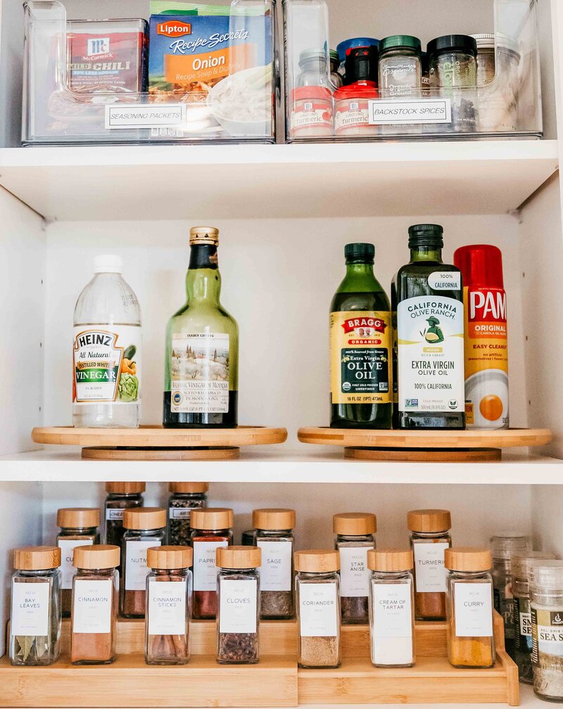 A spice cabinet showing neatly organized spices and cooking supplies