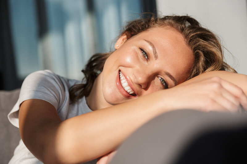 Young Woman laying on side smiling