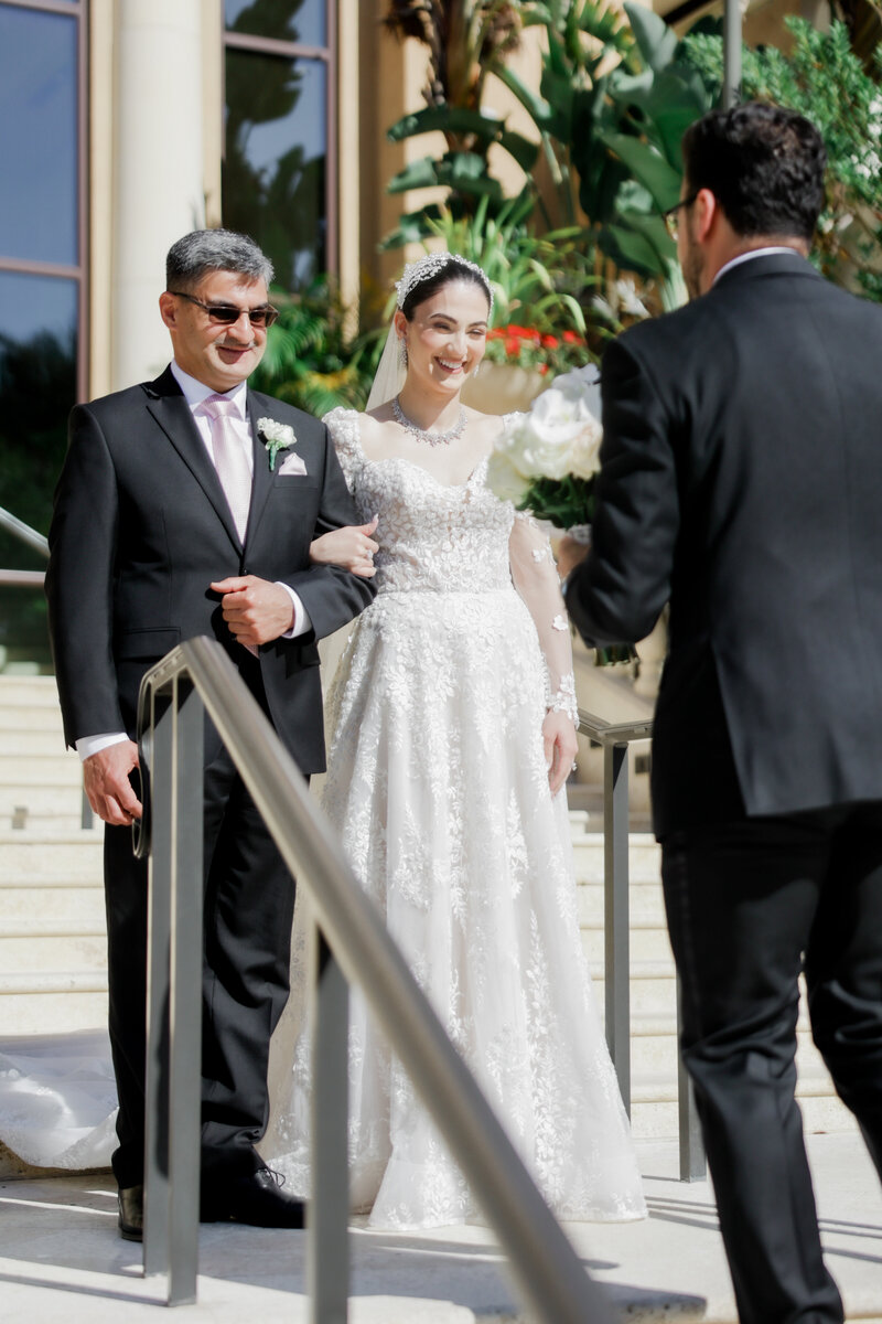 groom's reaction to the first look at the grand staircase at a wedding at the four seasons Orlando by Florida wedding photographer.