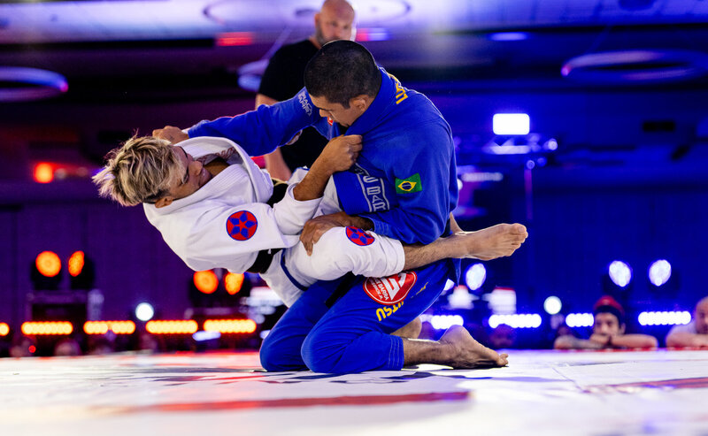 Two black belts grappling in Gi at F2W
