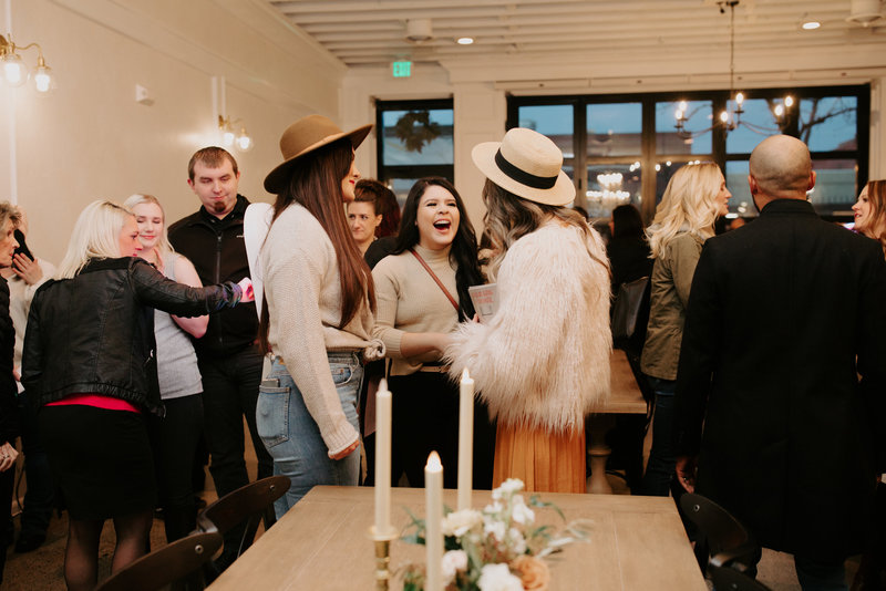 People laughing and talking at an event in our studio