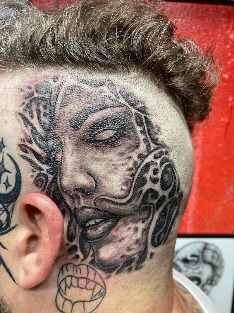 Dark Art Collective head tattoo