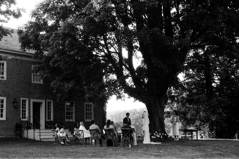 Two woman walking to their wedding reception among friends and family