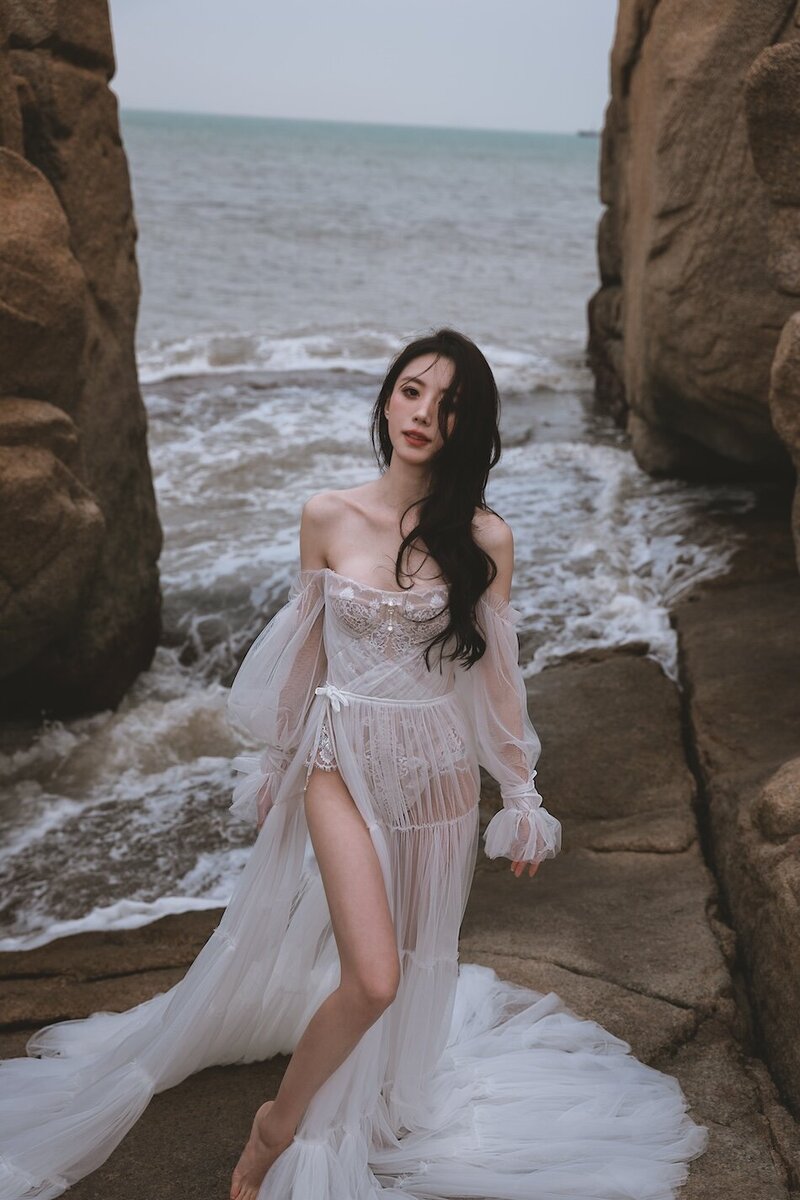 A beautiful windswept beach couture shoot amongst coastal rocks.