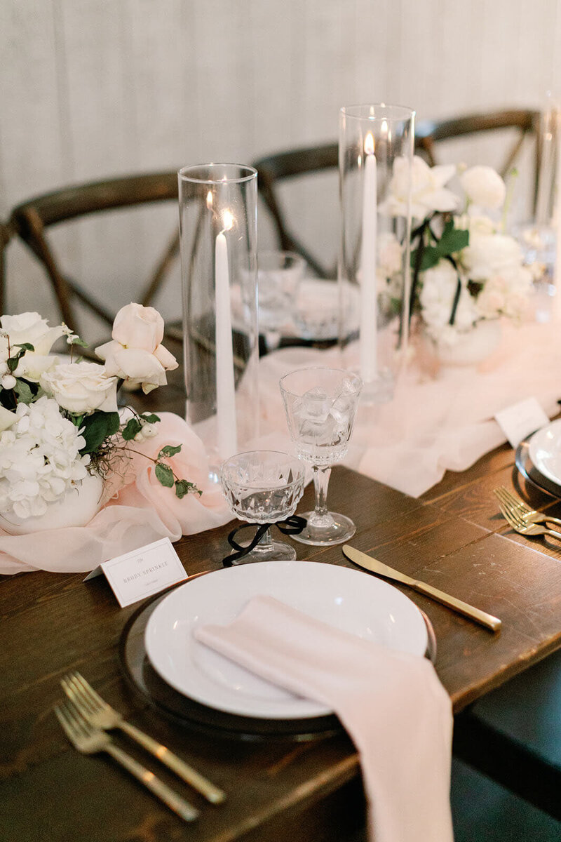Beautiful beach wedding tablescape with flowers, candelabras, and crystals