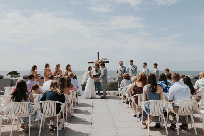 couple getting married in front of cross