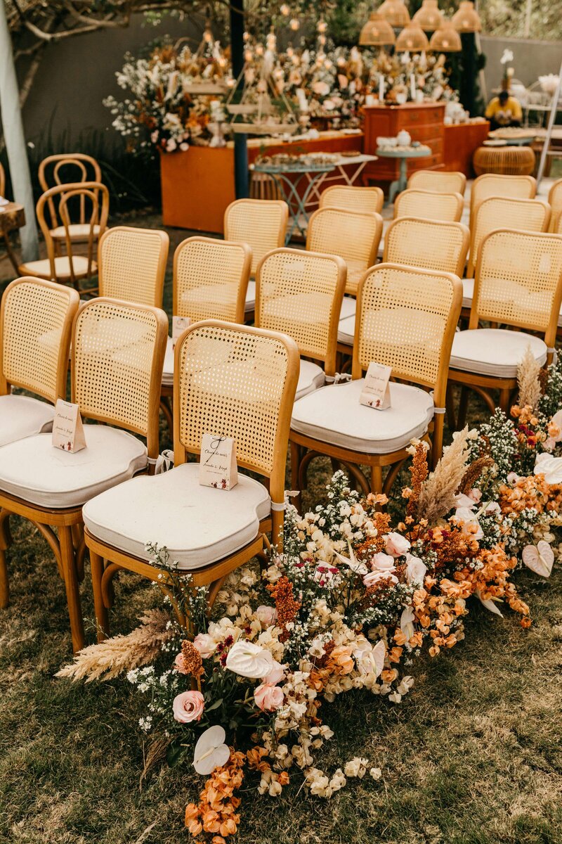 Wedding flowers and place cards ceremony seats at an outdoor wedding representing the variety of bridal show vendors one can meet at the Crush Collective wedding expo.