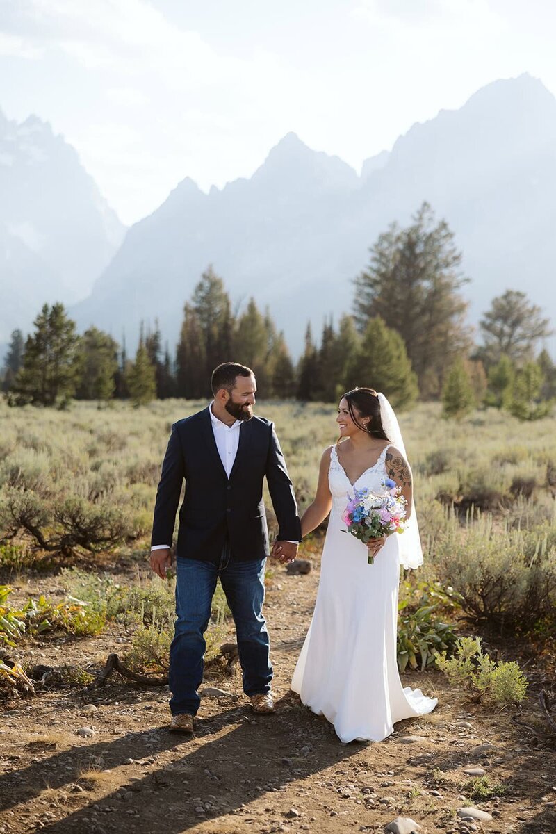 A couple looking into each others eyes laughing in the Sawtooth mountains in Stanley, Idaho